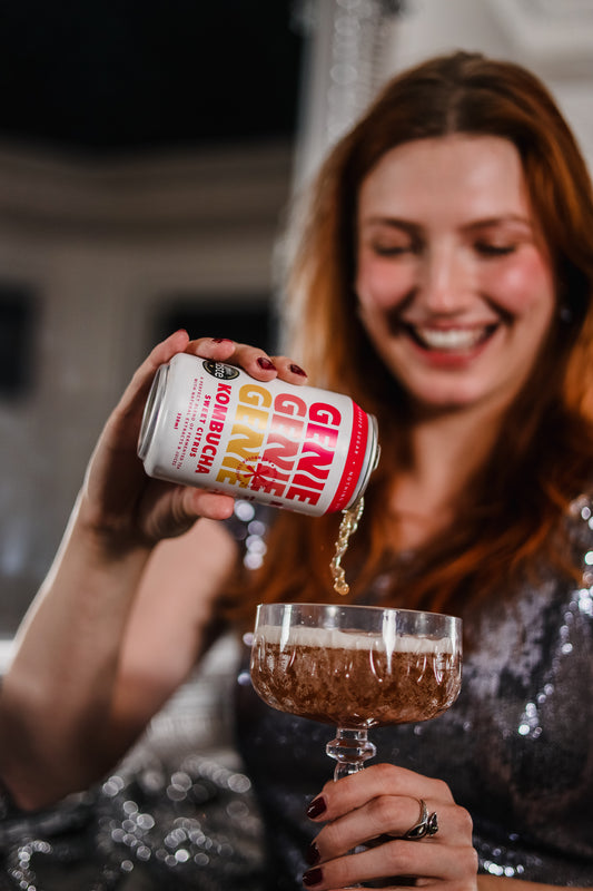 Woman Pouring Genie into a cocktail glass at a party